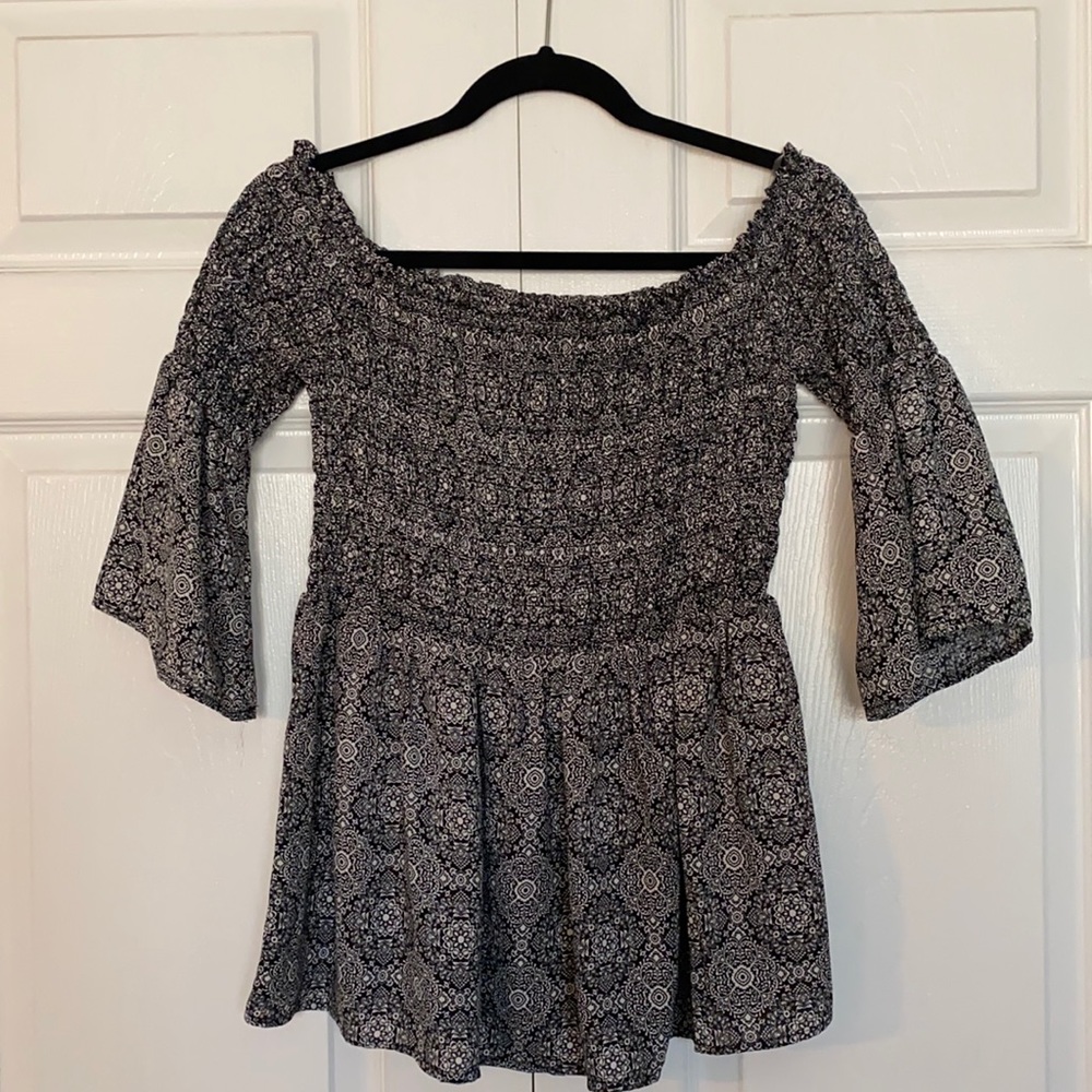 Society Girl Peplum top with bell sleeves in a size M